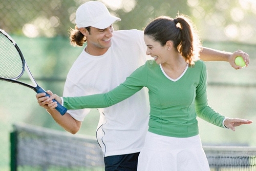 Couple playing tennis