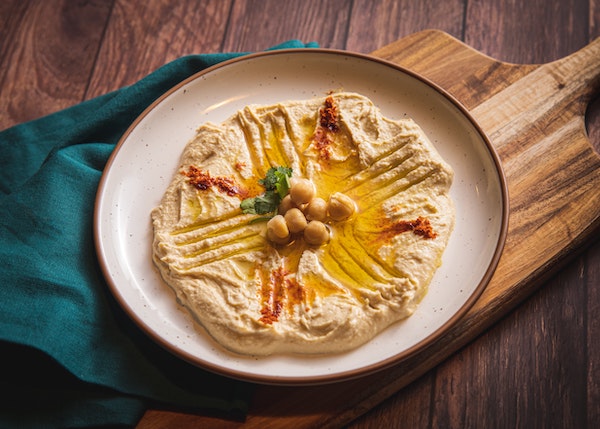 a plate of hummus with paprika