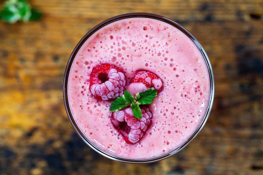 Healthy pink smoothie with frozen berries